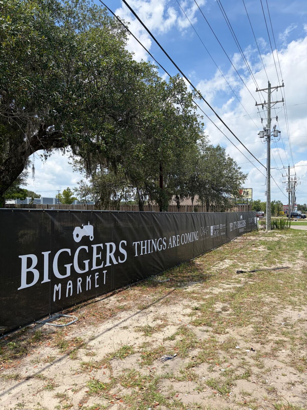Branded windscreen banner on temporary fence at a commercial property