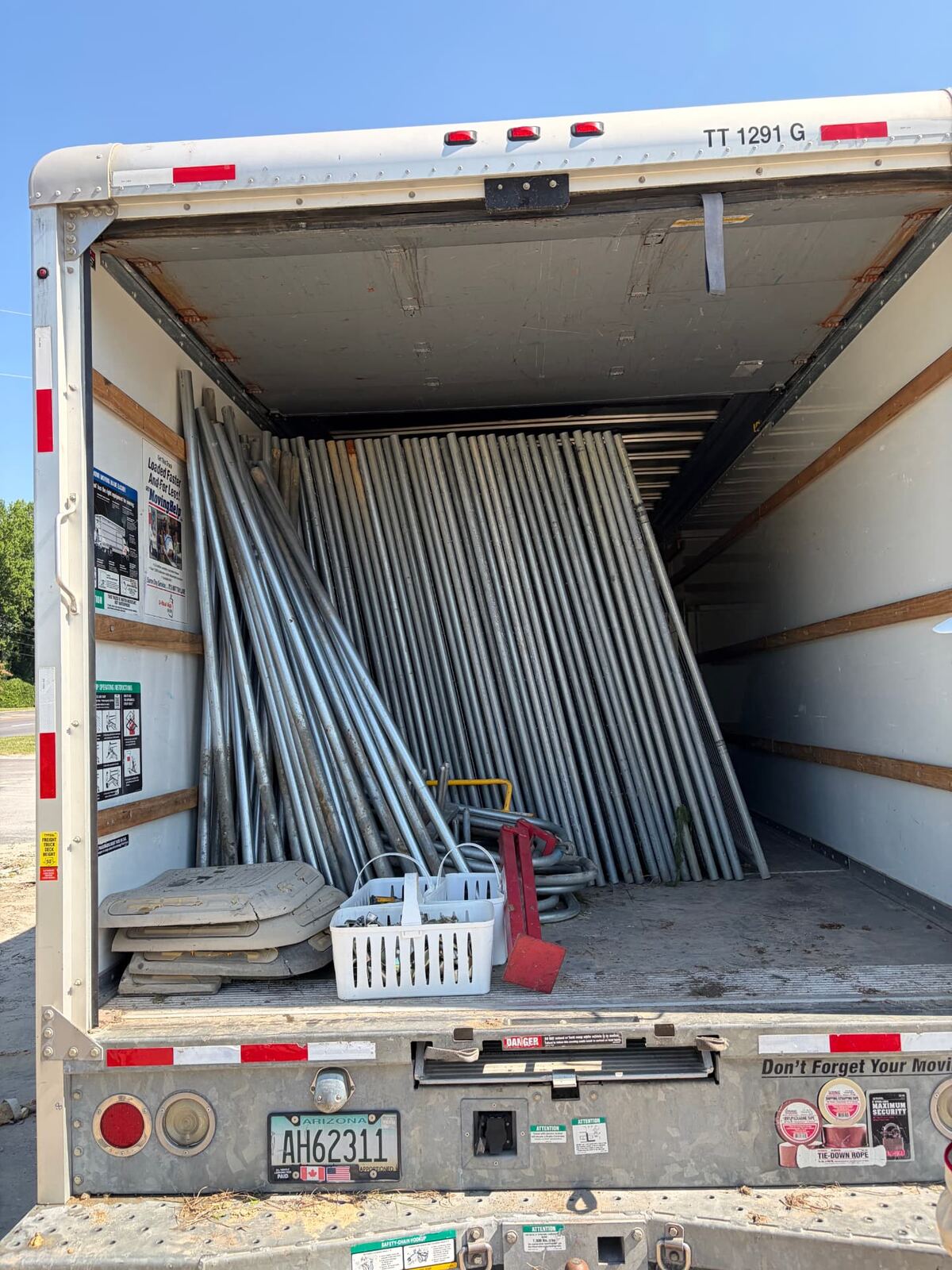 Box truck loaded with temporary fence panels and stands for delivery